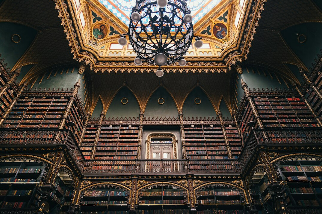 Old library with tall wooden shelves full of books